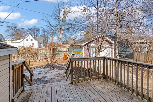 wooden deck featuring an outdoor structure and fence