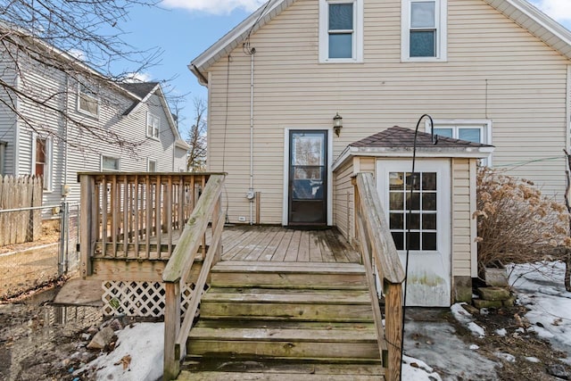 back of house featuring a wooden deck and fence