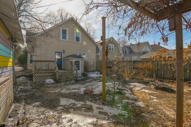 rear view of property with a deck and a fenced backyard