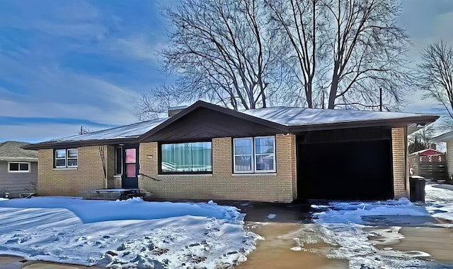 view of front facade featuring a garage and brick siding