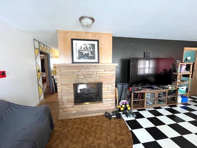 living room with tile patterned floors and a fireplace