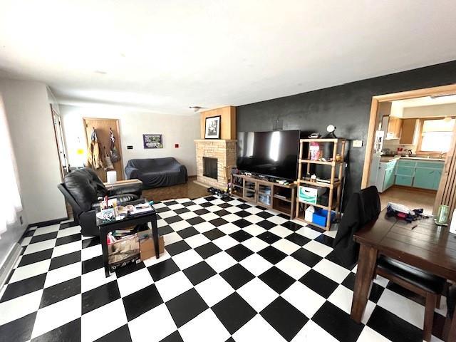 living room with tile patterned floors and a fireplace