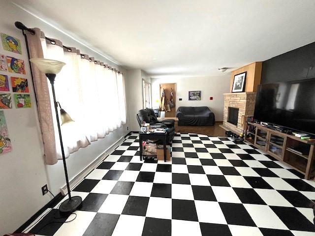 interior space with tile patterned floors and a brick fireplace