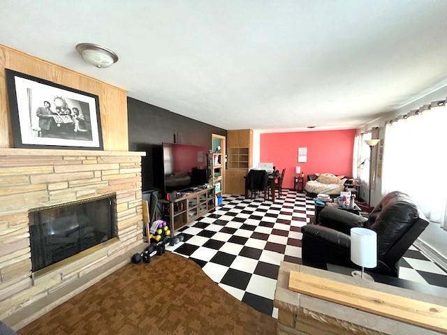 living room featuring tile patterned floors and a fireplace