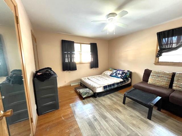 bedroom featuring wood finished floors and ceiling fan