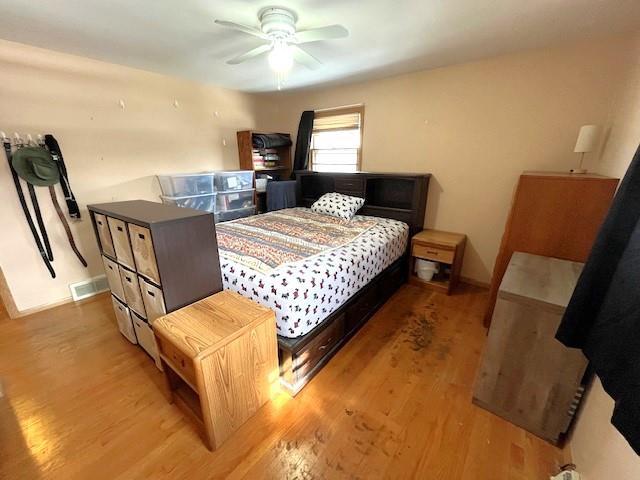 bedroom with visible vents, ceiling fan, baseboards, and light wood-style floors