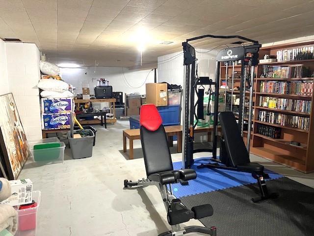 exercise area featuring concrete block wall