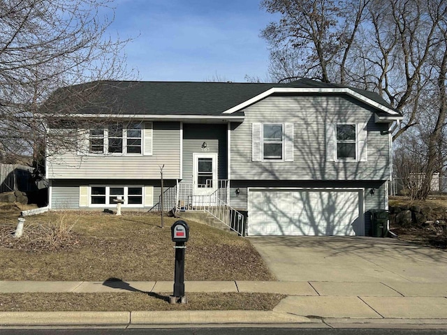 split foyer home featuring an attached garage and driveway