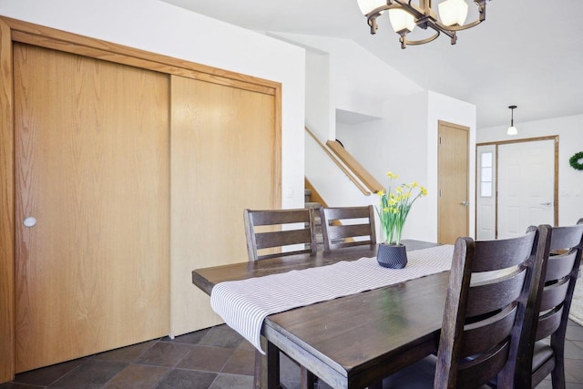 dining area featuring a notable chandelier and stairs