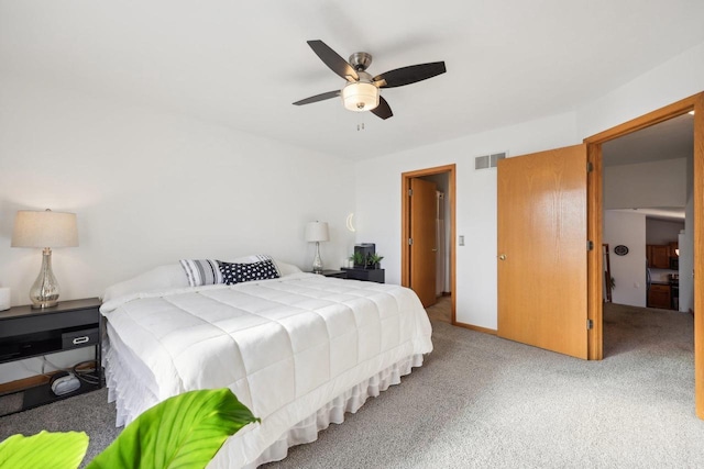 bedroom featuring visible vents, ceiling fan, and carpet