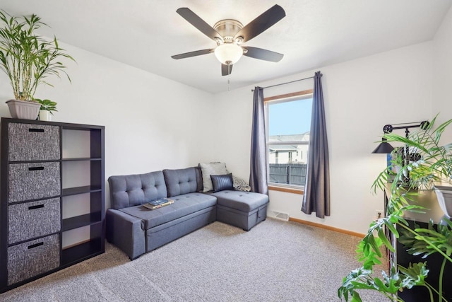 living area with a ceiling fan, visible vents, carpet, and baseboards