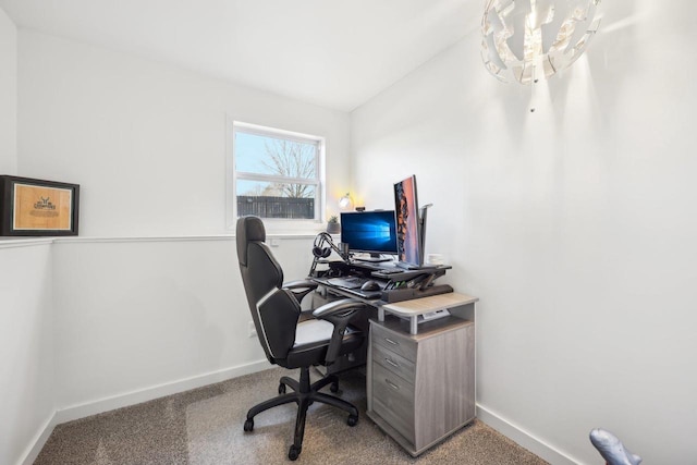 office space with a notable chandelier, baseboards, and carpet floors