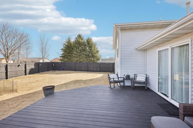 wooden terrace featuring a fenced backyard