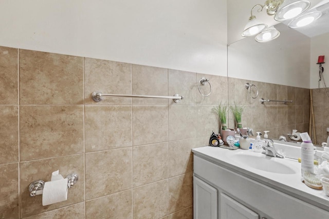 bathroom featuring vanity and tile walls