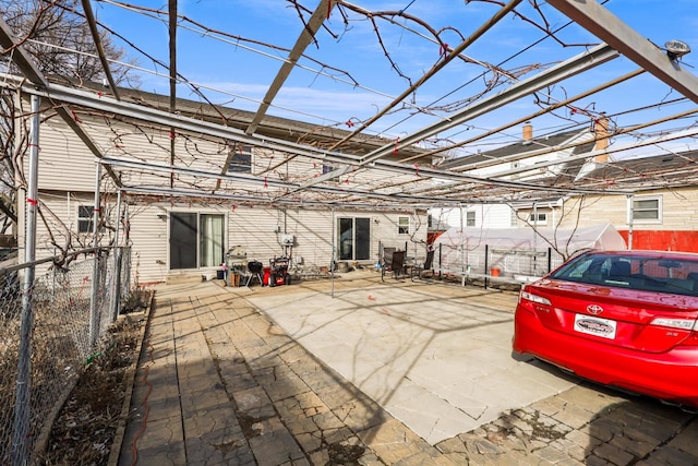 rear view of house featuring a patio area and a fenced backyard