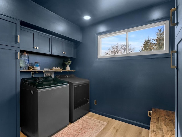 clothes washing area featuring baseboards, recessed lighting, light wood-style flooring, cabinet space, and independent washer and dryer