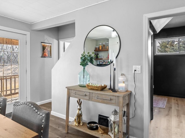 interior space with baseboards and wood finished floors