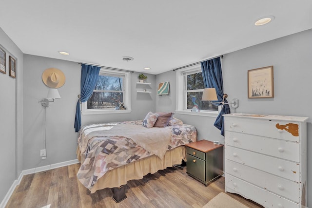 bedroom featuring recessed lighting, visible vents, baseboards, and wood finished floors