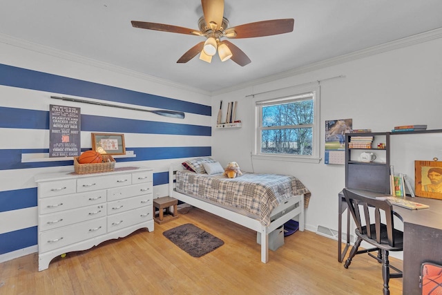 bedroom featuring light wood finished floors, crown molding, and ceiling fan