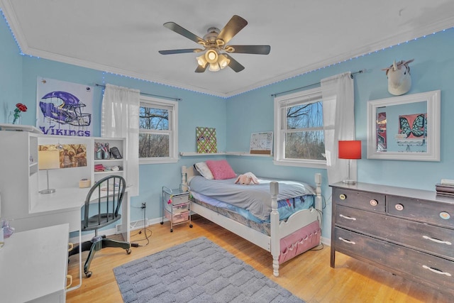 bedroom featuring wood finished floors, baseboards, and ornamental molding