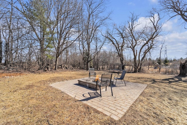 view of yard featuring a fire pit and a patio