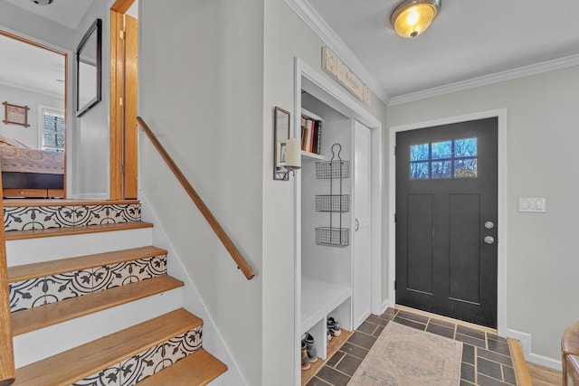 entryway featuring stairs, baseboards, and ornamental molding