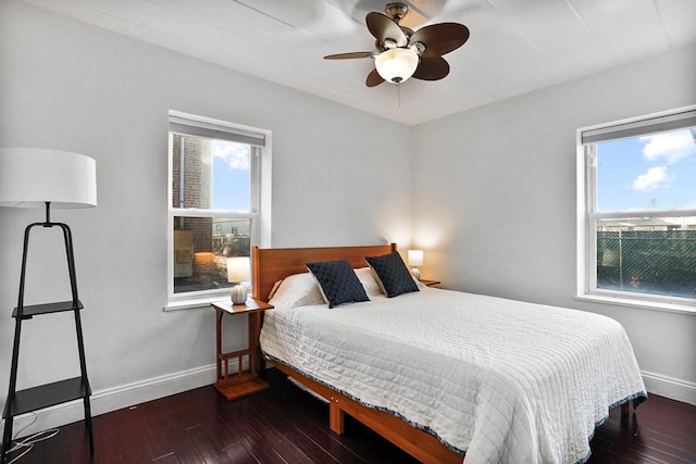 bedroom with ceiling fan, baseboards, and wood-type flooring