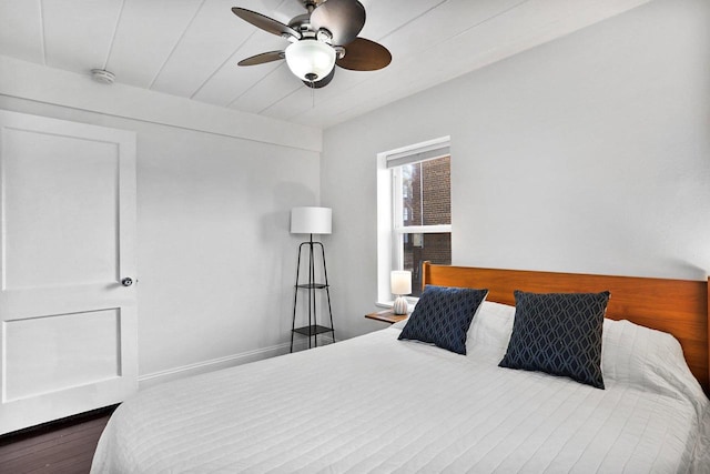 bedroom featuring wood finished floors, baseboards, and ceiling fan