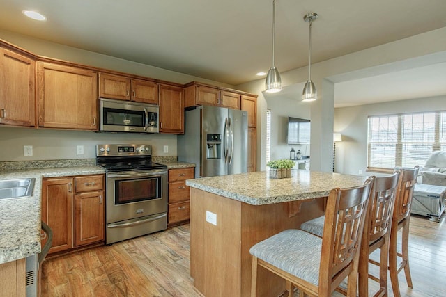 kitchen with appliances with stainless steel finishes, light wood-style flooring, and light countertops