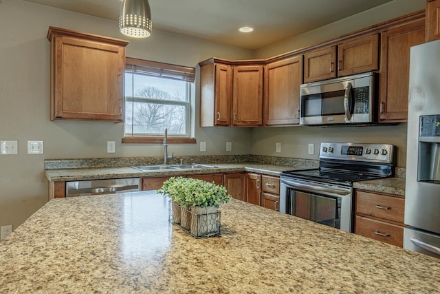 kitchen with recessed lighting, brown cabinets, hanging light fixtures, stainless steel appliances, and a sink