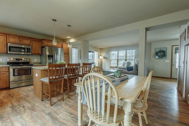 dining room with light wood-style flooring and baseboards