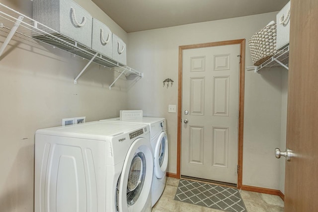 clothes washing area featuring laundry area, baseboards, and separate washer and dryer