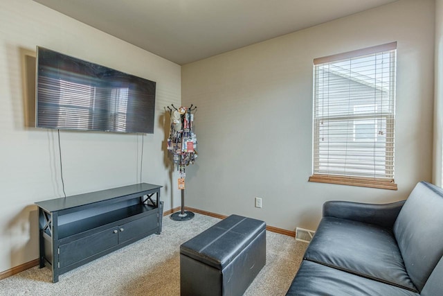 sitting room with baseboards and carpet floors