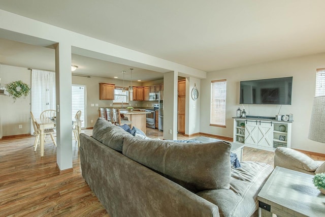 living room with light wood finished floors and baseboards