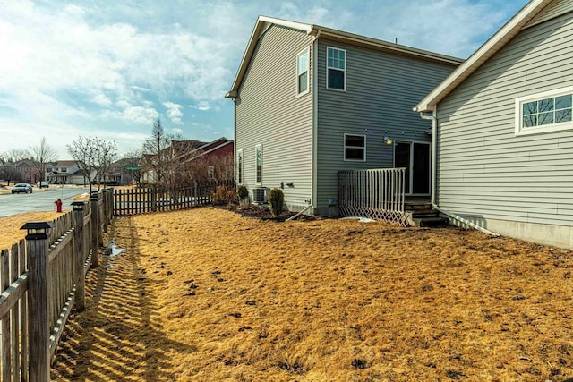 view of home's exterior with a residential view, cooling unit, and fence