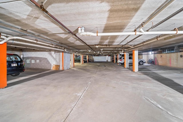 parking garage featuring concrete block wall