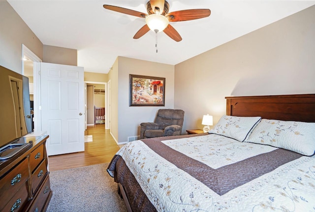 bedroom with baseboards, wood finished floors, and a ceiling fan