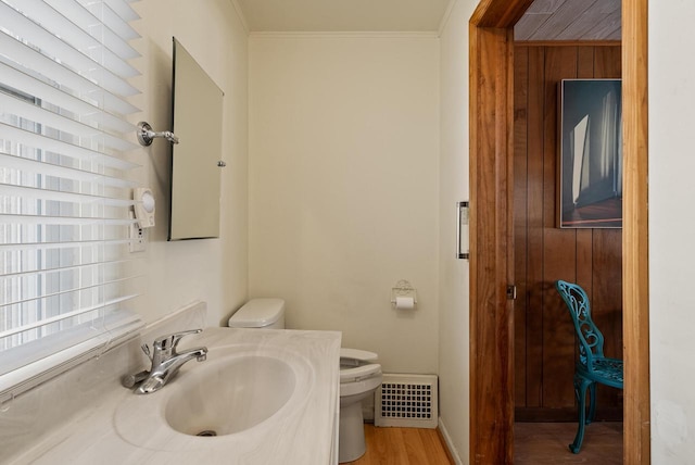 bathroom with vanity, baseboards, visible vents, crown molding, and toilet