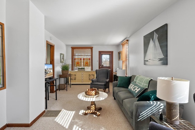 carpeted living area with baseboards