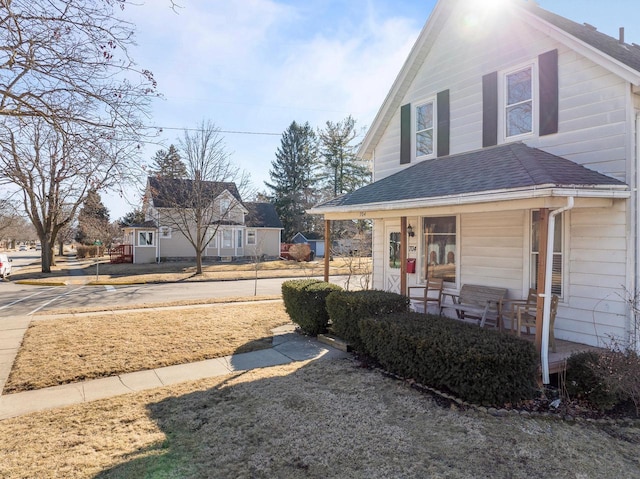 exterior space featuring a porch and roof with shingles