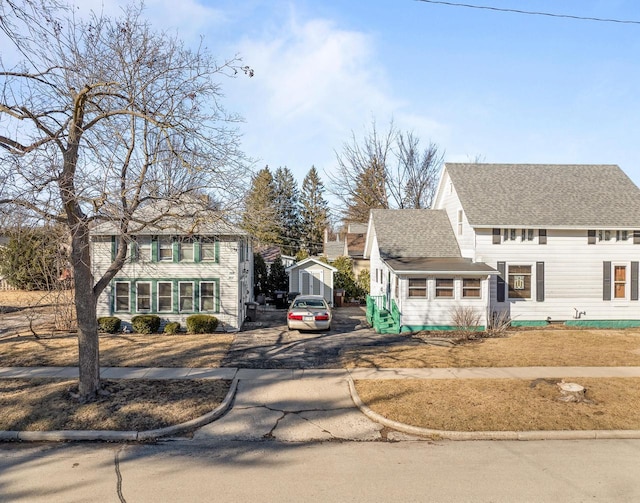 view of front of property featuring roof with shingles