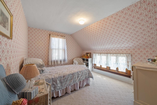 bedroom with light carpet, wallpapered walls, and lofted ceiling