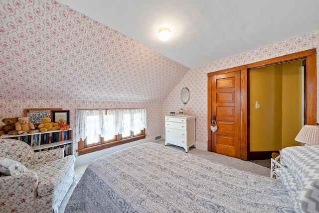 carpeted bedroom with wallpapered walls, baseboards, and visible vents