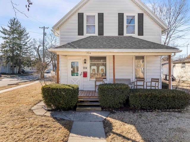 view of front of property with a porch and roof with shingles