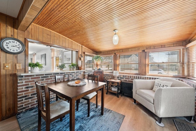 sunroom / solarium featuring lofted ceiling and wood ceiling