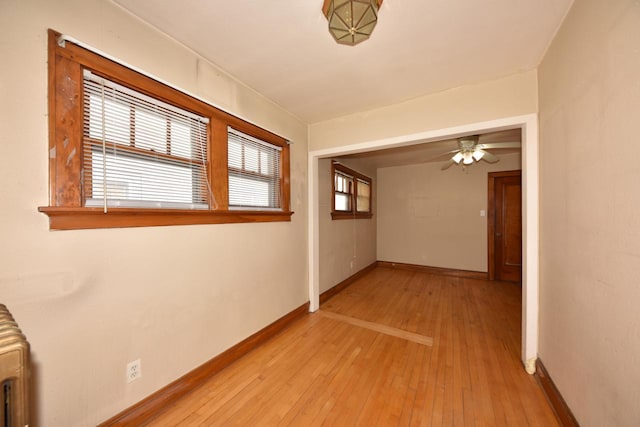 interior space featuring baseboards and light wood-style floors