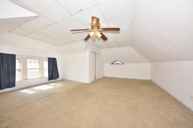 bonus room with ceiling fan, vaulted ceiling, and light carpet