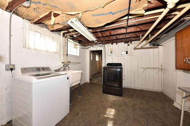 clothes washing area featuring washer and dryer and a sink