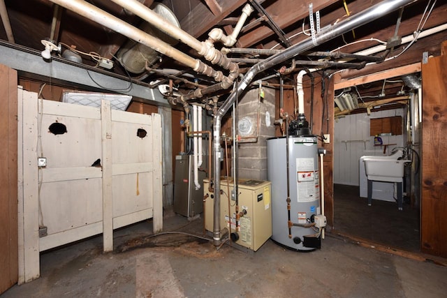 unfinished below grade area with gas water heater, a heating unit, and a sink