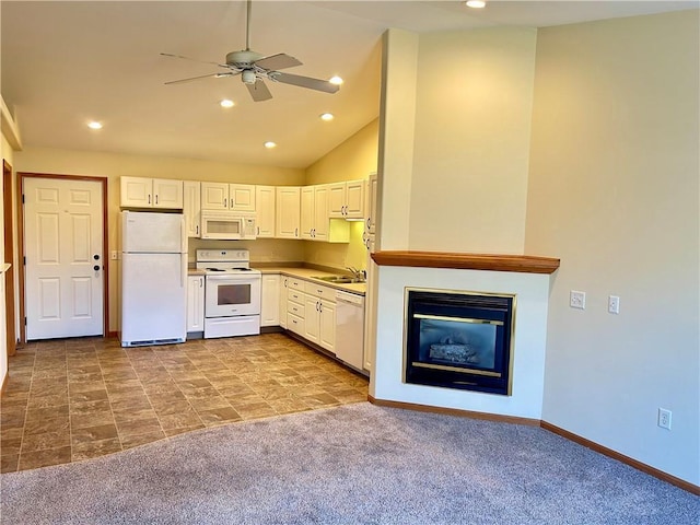 kitchen featuring white cabinetry, white appliances, carpet flooring, and a sink